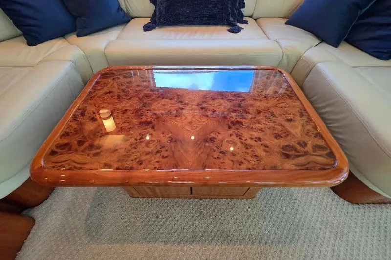 Blue Bird Yacht Photos Pics Luxurious wooden table on Neptunus Flybridge MY 2008 yacht, surrounded by beige seating.