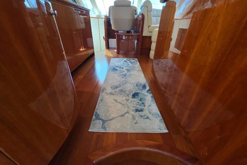 Blue Bird Yacht Photos Pics Luxurious interior of 2008 Neptunus Flybridge MY yacht with polished wood and elegant rug.