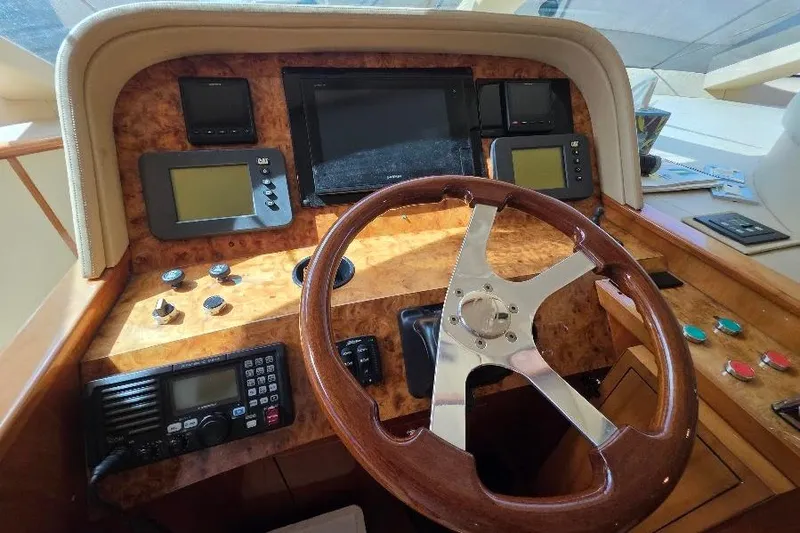 Blue Bird Yacht Photos Pics Helm of 2008 Neptunus Flybridge MY yacht with wooden steering wheel and navigation instruments.