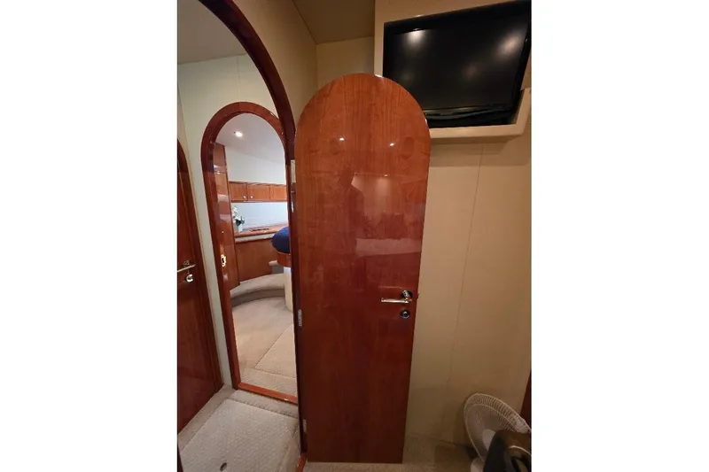 Blue Bird Yacht Photos Pics Interior of 2008 Neptunus Flybridge MY yacht with wooden doors and mounted TV.