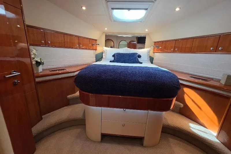 Blue Bird Yacht Photos Pics Luxurious 2008 Neptunus Flybridge MY yacht bedroom with elegant wood finishes and cozy bedding.