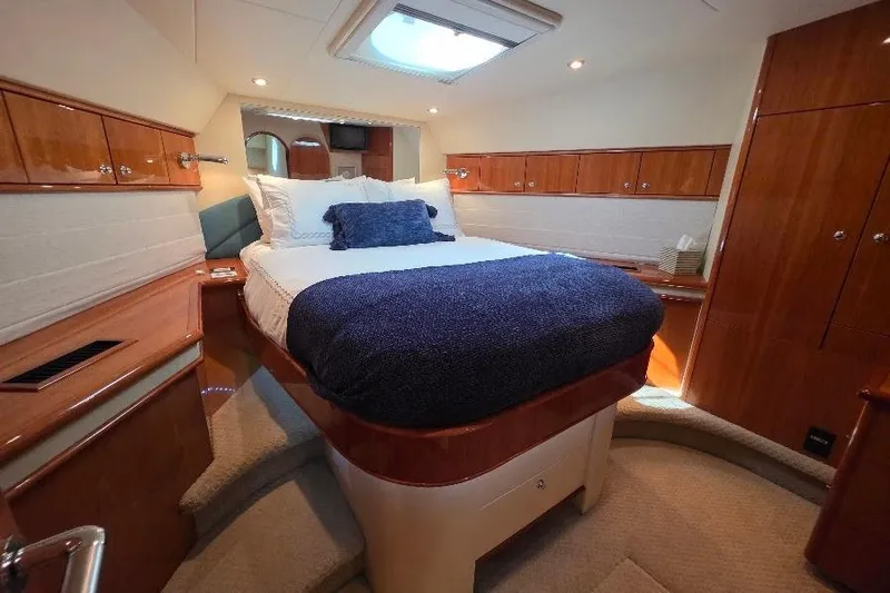 Blue Bird Yacht Photos Pics Luxurious bedroom interior of 2008 Neptunus Flybridge MY yacht with elegant wood finishes.