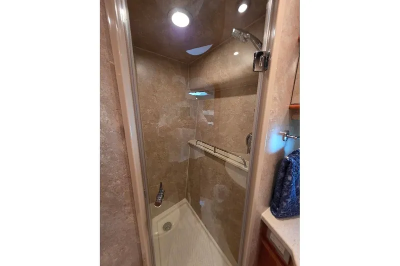 Blue Bird Yacht Photos Pics Shower area in 2008 Neptunus Flybridge MY yacht with glass door and beige interior.