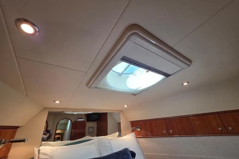 Blue Bird Yacht Photos Pics Interior of 2008 Neptunus Flybridge MY yacht with skylight and wooden cabinetry.