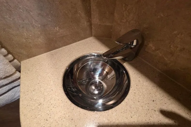 Blue Bird Yacht Photos Pics Stainless steel sink and faucet in Neptunus Flybridge MY 2008 yacht bathroom.