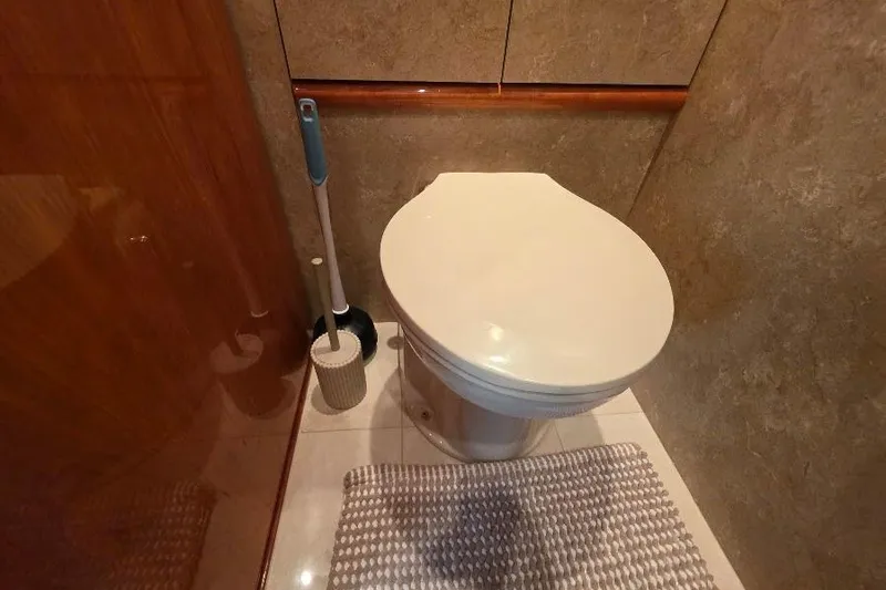 Blue Bird Yacht Photos Pics Bathroom interior of 2008 Neptunus Flybridge MY yacht with toilet and cleaning brush.