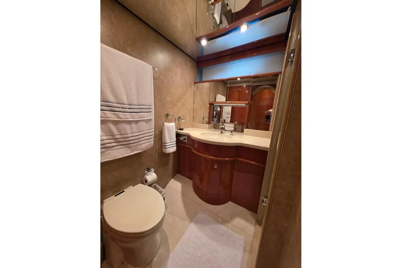 Blue Bird Yacht Photos Pics Luxurious bathroom in 2008 Neptunus Flybridge MY yacht with elegant wood cabinetry.
