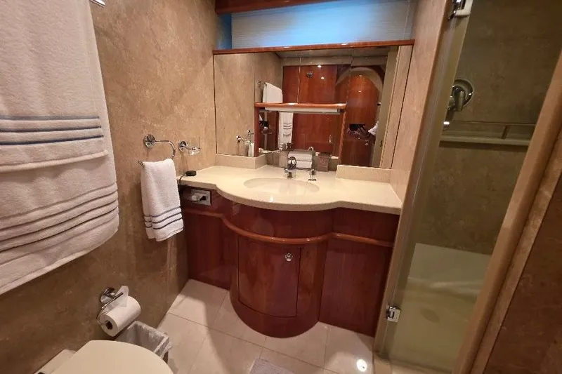 Blue Bird Yacht Photos Pics Luxurious bathroom in 2008 Neptunus Flybridge MY yacht with elegant wood cabinetry.