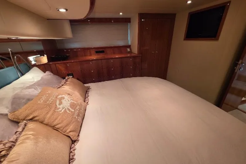 Blue Bird Yacht Photos Pics Luxurious bedroom interior of 2008 Neptunus Flybridge MY yacht with elegant wood finishes.