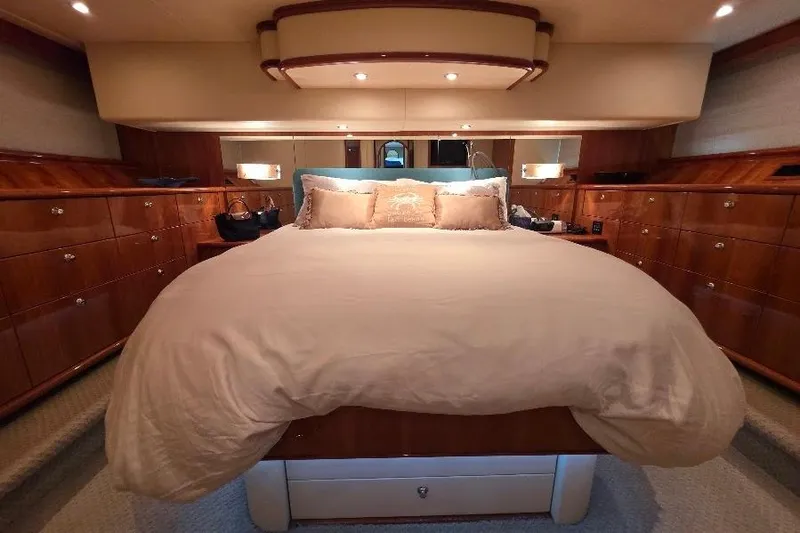 Blue Bird Yacht Photos Pics Luxurious bedroom interior of 2008 Neptunus Flybridge MY yacht with elegant wood finish.