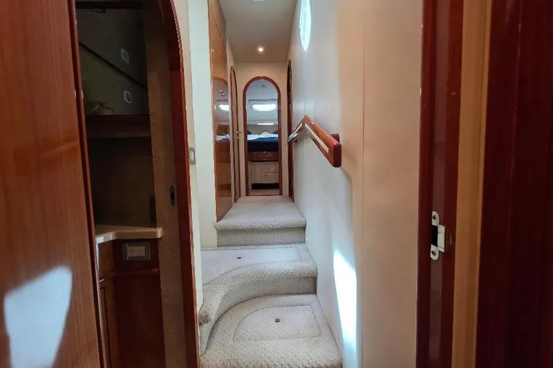 Blue Bird Yacht Photos Pics Interior hallway of 2008 Neptunus Flybridge MY yacht with carpeted stairs and wooden accents.