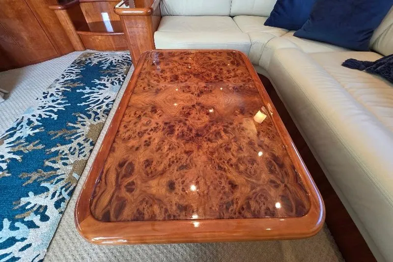 Blue Bird Yacht Photos Pics Luxurious wooden table on Neptunus Flybridge MY 2008 yacht, surrounded by elegant seating.