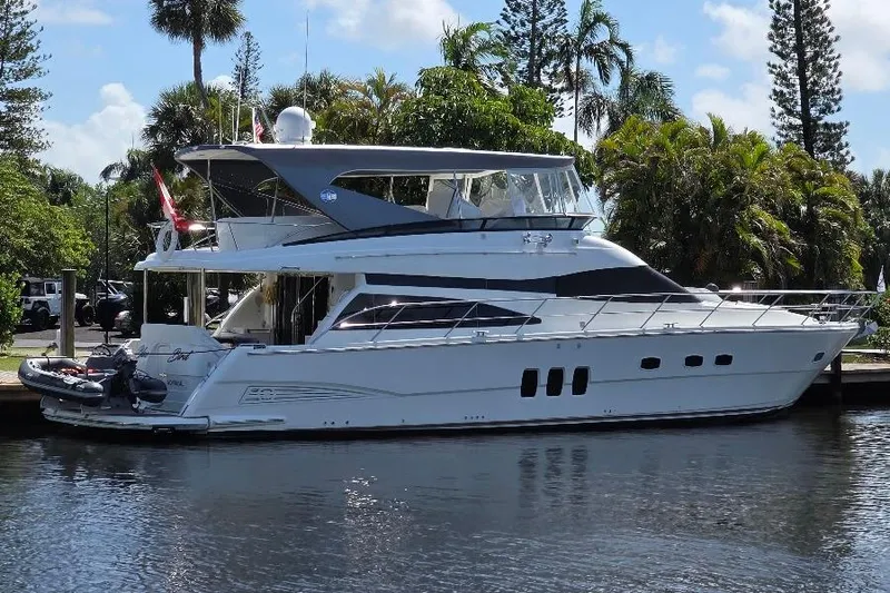 Blue Bird Yacht Photos Pics 2008 Neptunus Flybridge MY yacht docked by lush greenery and calm waters.