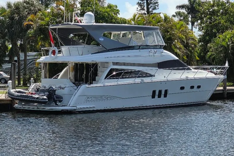 Blue Bird Yacht Photos Pics Luxury 2008 Neptunus Flybridge MY yacht docked by lush greenery.