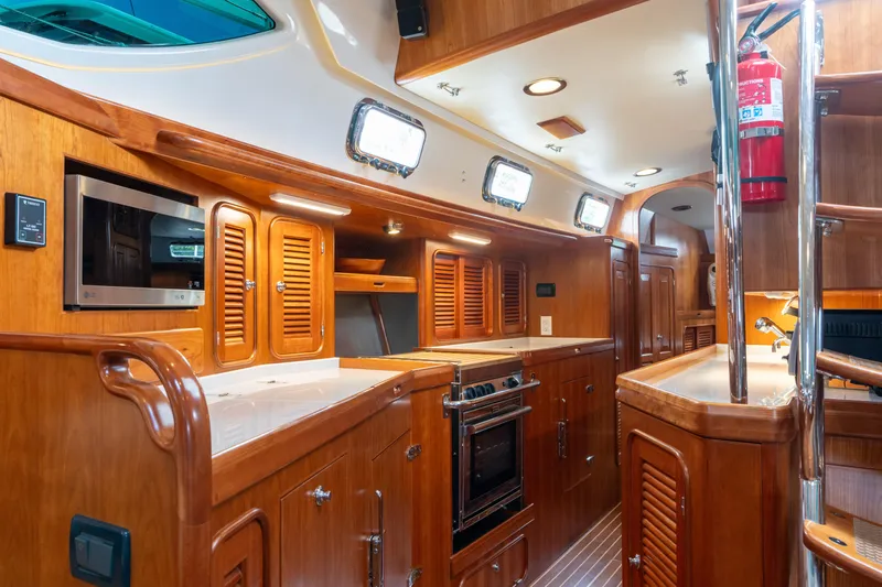 Solitude Yacht Photos Pics Luxurious 2018 Passport Vista 545 yacht interior with modern kitchen and wooden cabinetry.