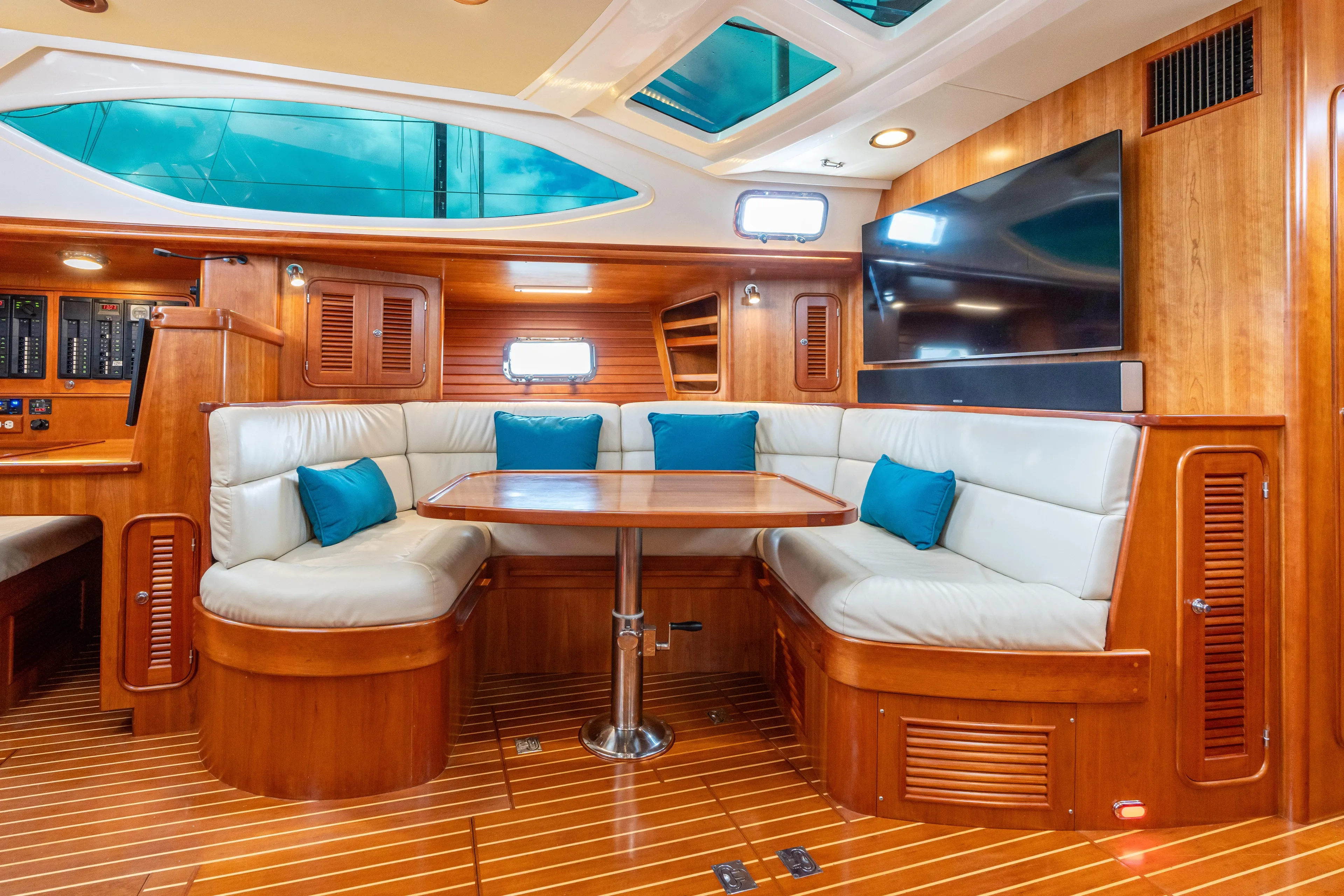 Solitude Yacht Photos Pics Luxurious interior of 2018 Passport Vista 545 Center Cockpit yacht with plush seating and wood finish.