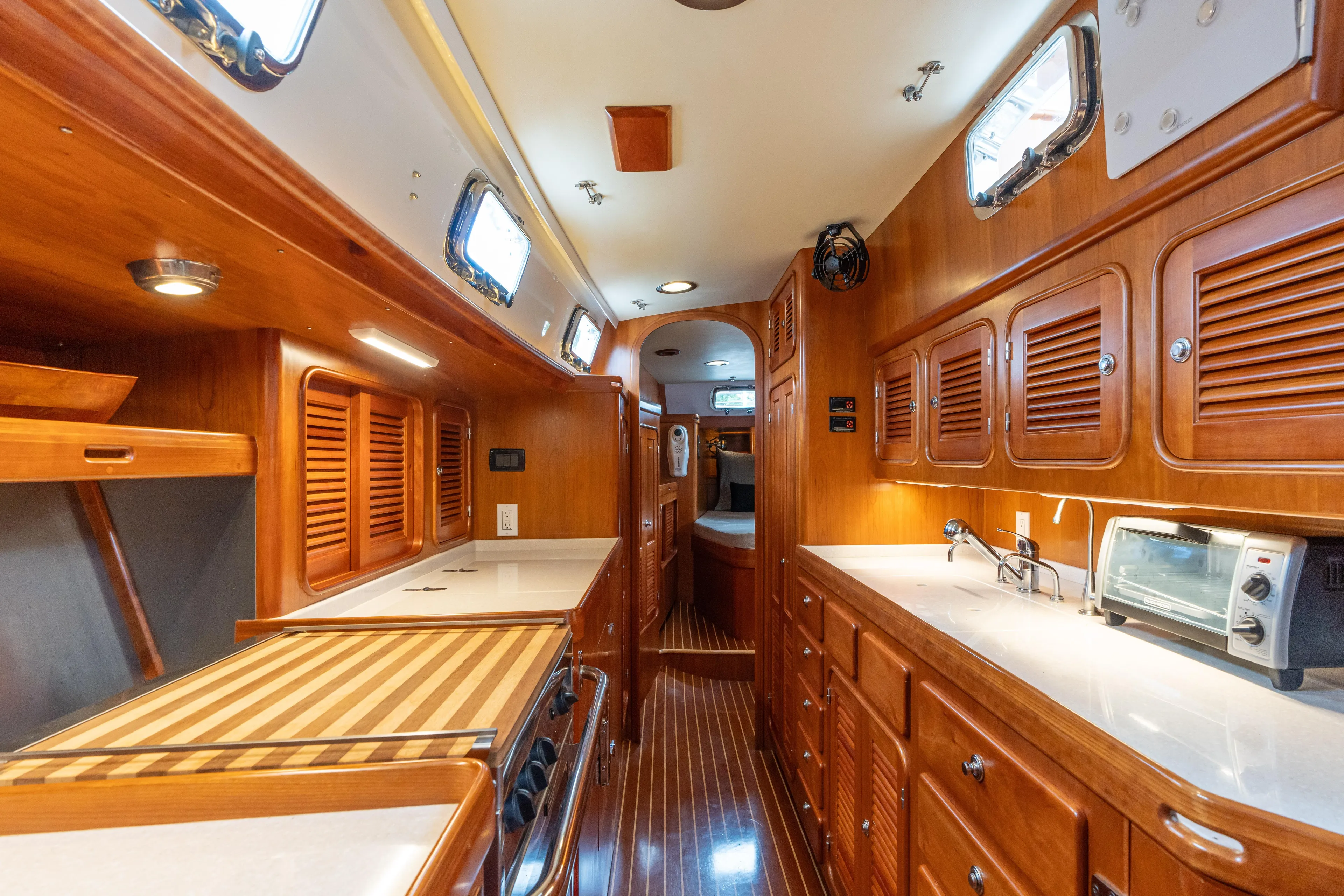 Solitude Yacht Photos Pics Luxurious 2018 Passport Vista 545 yacht interior with wooden cabinetry and modern amenities.