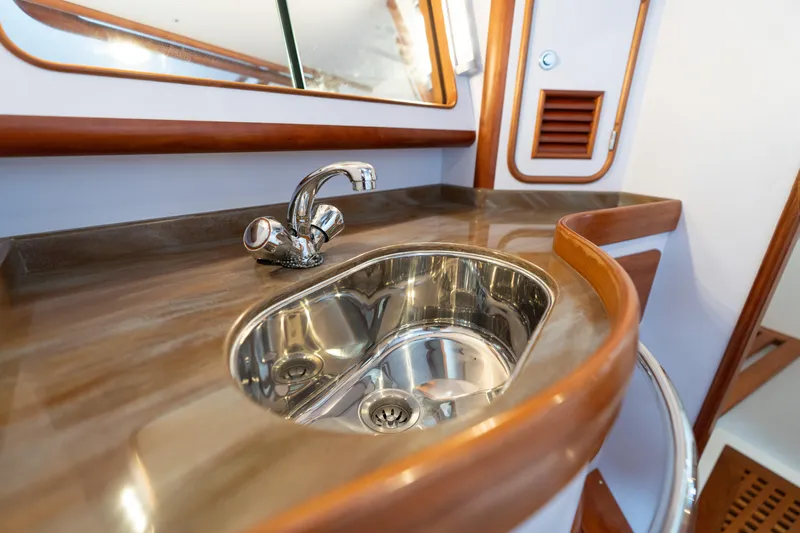 Solitude Yacht Photos Pics Luxurious sink area in 2018 Passport Vista 545 Center Cockpit yacht bathroom.