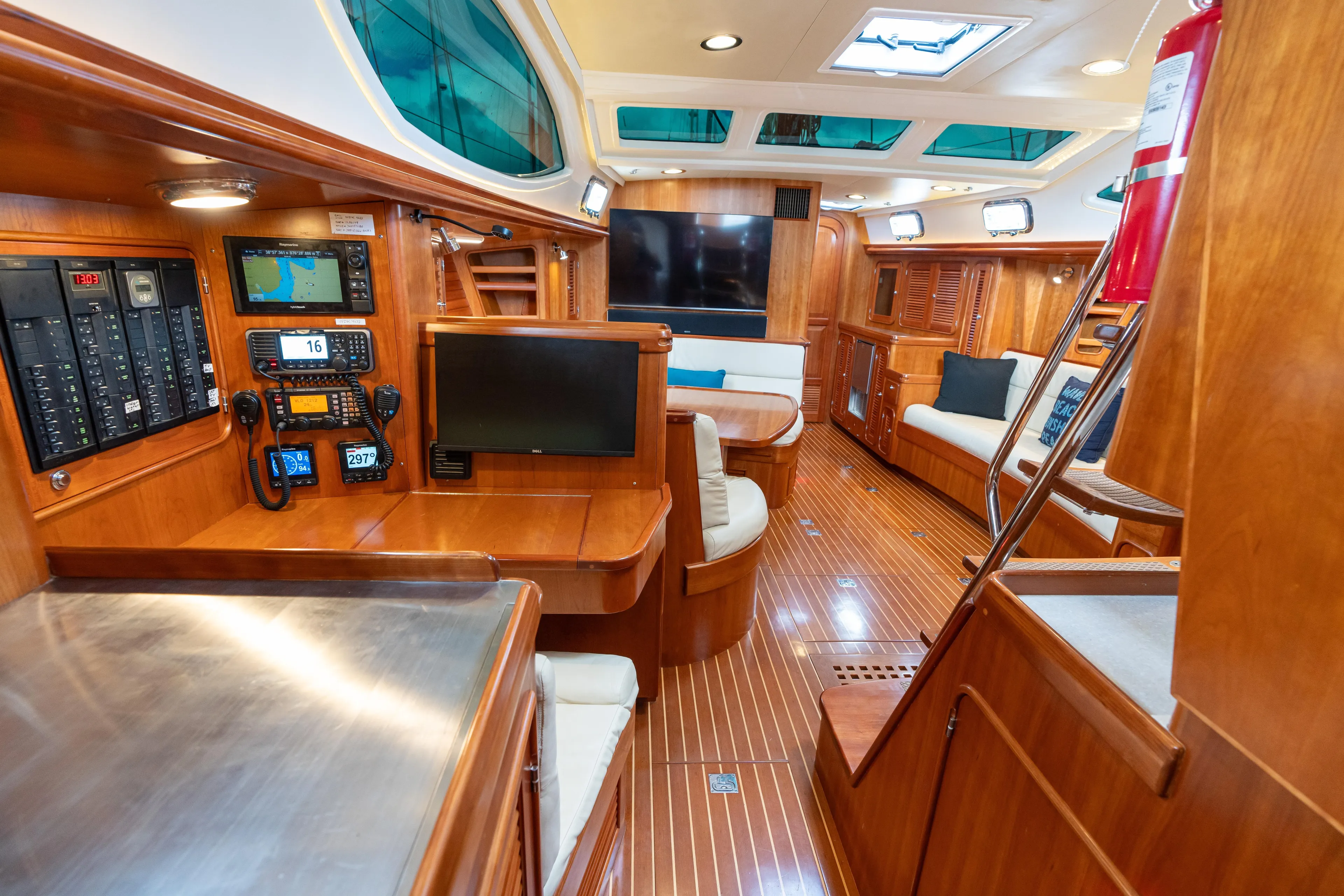 Solitude Yacht Photos Pics Luxurious interior of 2018 Passport Vista 545 Center Cockpit yacht with navigation equipment and seating.