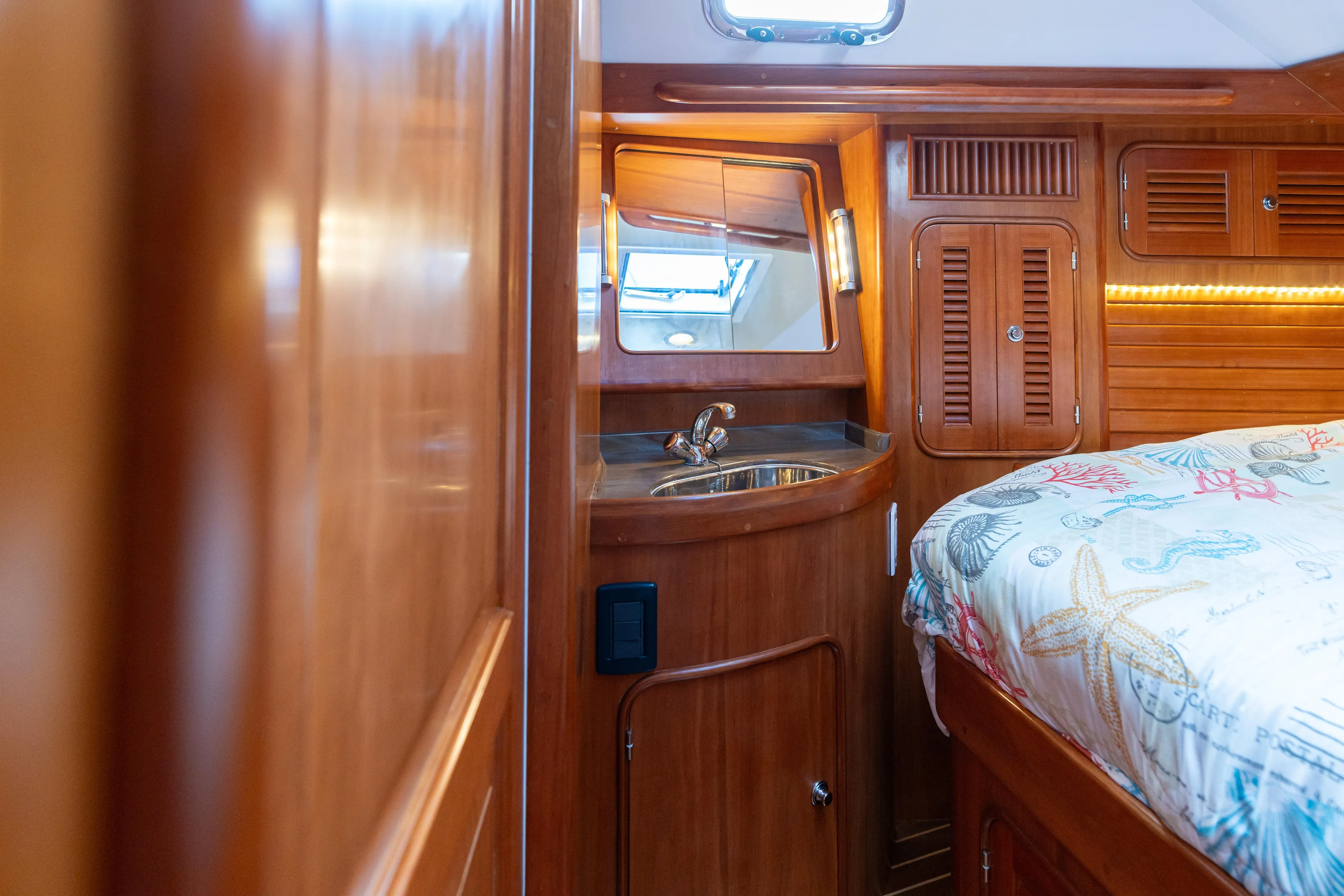 Solitude Yacht Photos Pics Luxurious 2018 Passport Vista 545 yacht interior with wood finish and cozy bedding.