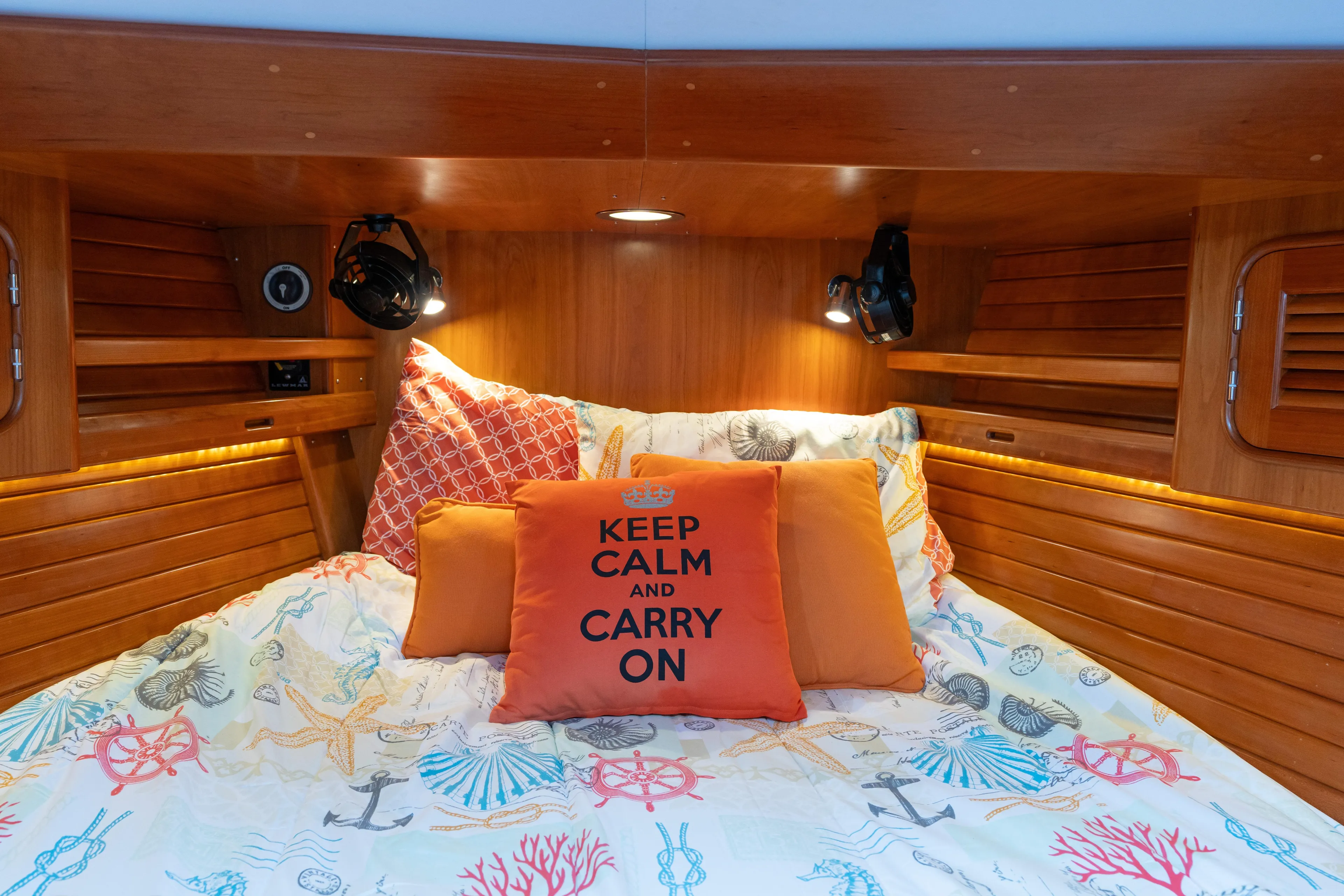 Solitude Yacht Photos Pics Cozy cabin interior of 2018 Passport Vista 545 Center Cockpit with nautical-themed bedding.
