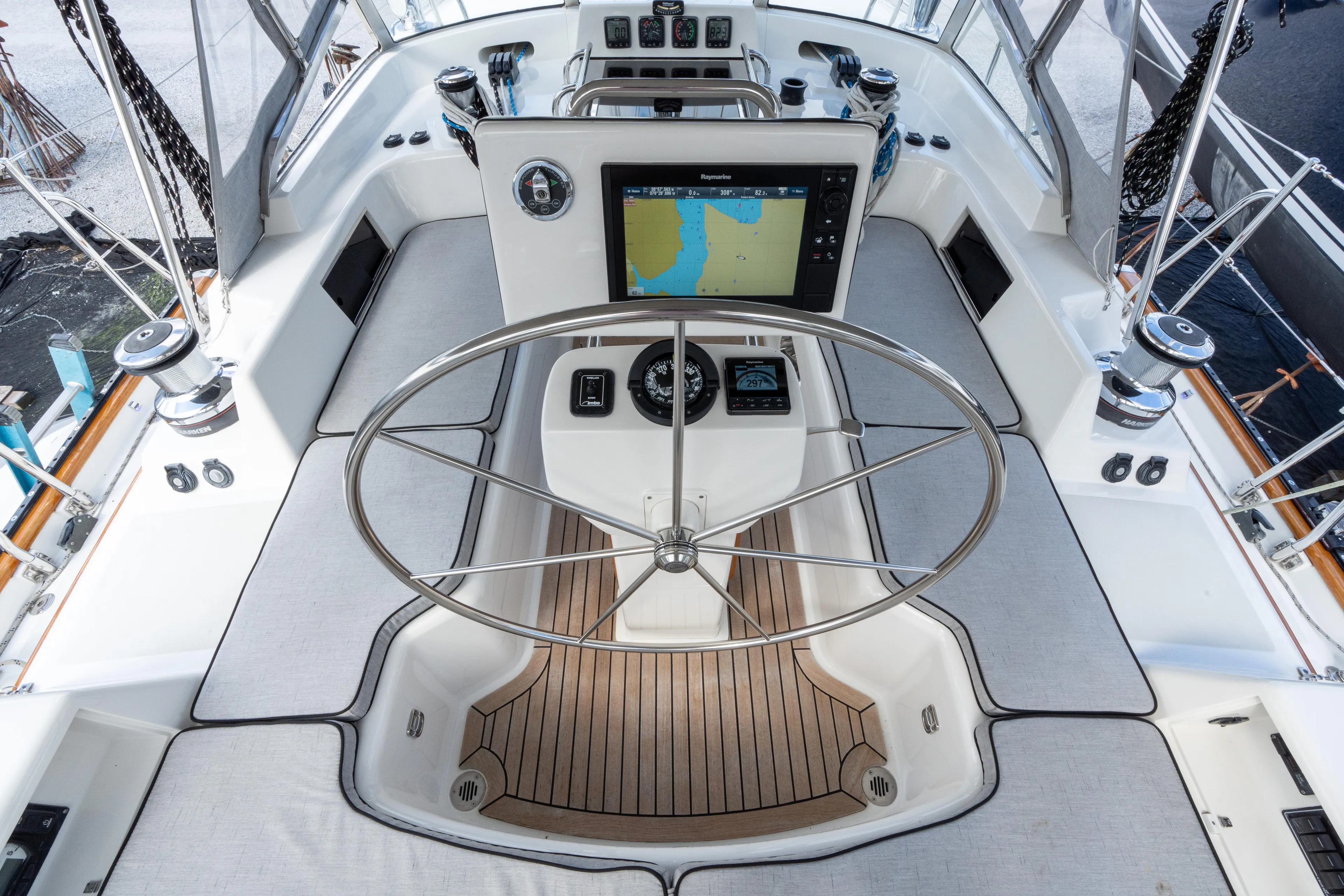 Solitude Yacht Photos Pics Center cockpit of 2018 Passport Vista 545 sailboat with navigation equipment and steering wheel.