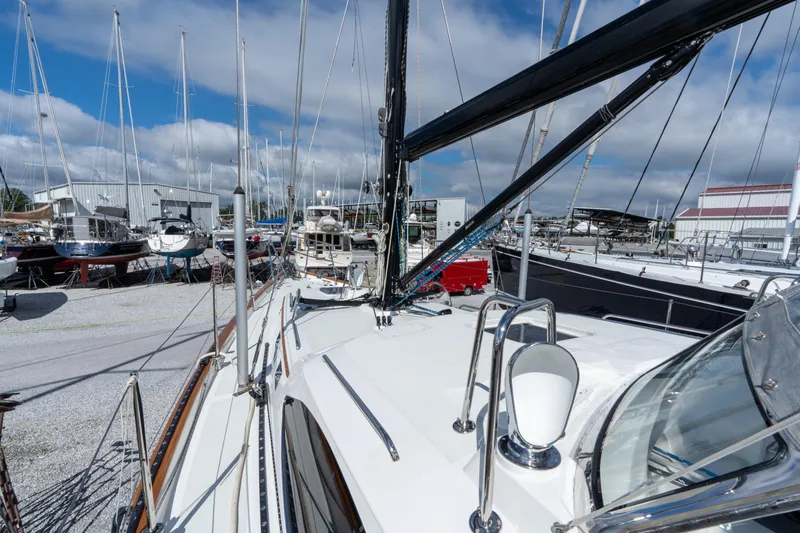 Solitude Yacht Photos Pics 2018 Passport Vista 545 Center Cockpit sailboat in a marina, surrounded by other boats.