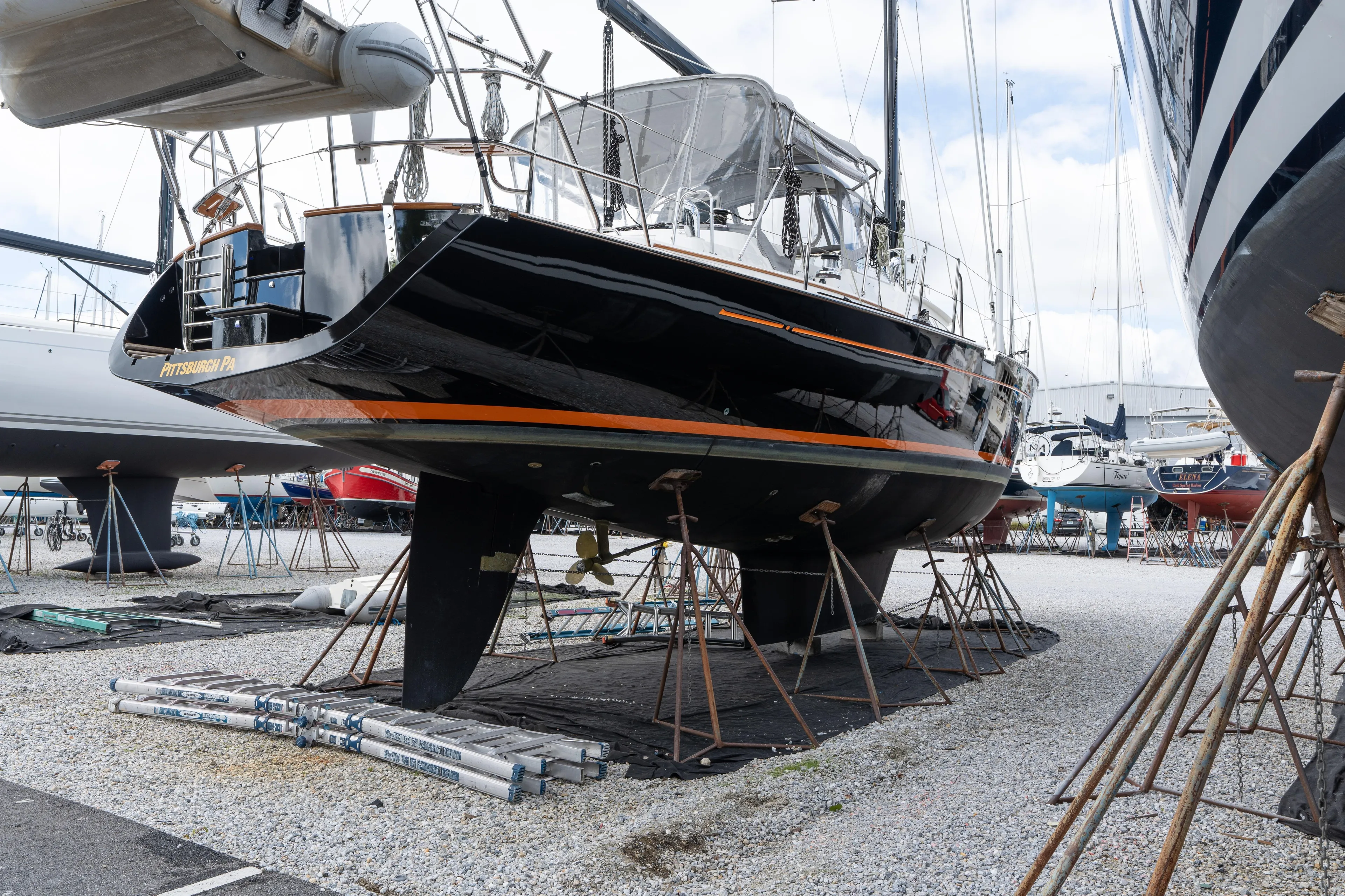 Solitude Yacht Photos Pics 2018 Passport Vista 545 Center Cockpit sailboat on stands in a boatyard.