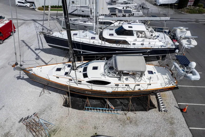 Solitude Yacht Photos Pics 2018 Passport Vista 545 Center Cockpit sailboat on dry dock, surrounded by other boats.