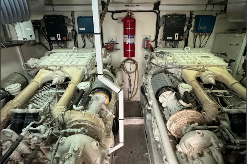  Yacht Photos Pics Engine room of a 2004 Princess V65 yacht, featuring dual engines and fire safety equipment.