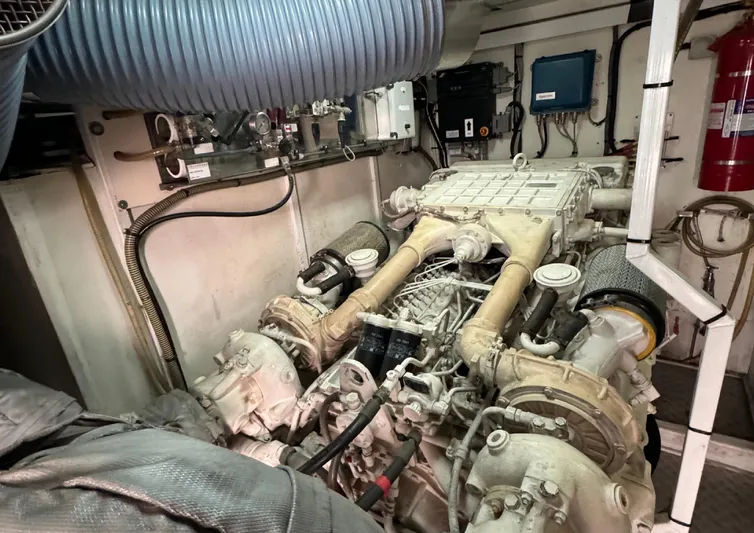  Yacht Photos Pics Engine room of a 2004 Princess V65 yacht, showcasing mechanical components and piping.