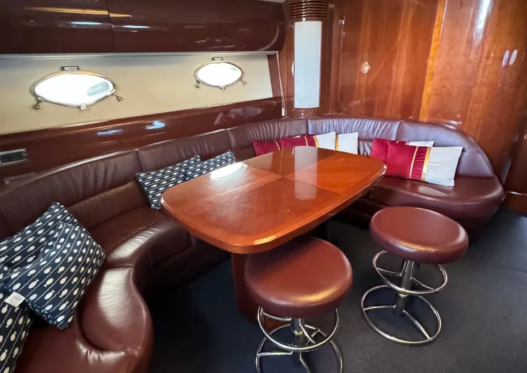 Yacht Photos Pics Luxurious interior of 2004 Princess V65 yacht with leather seating and wooden table.