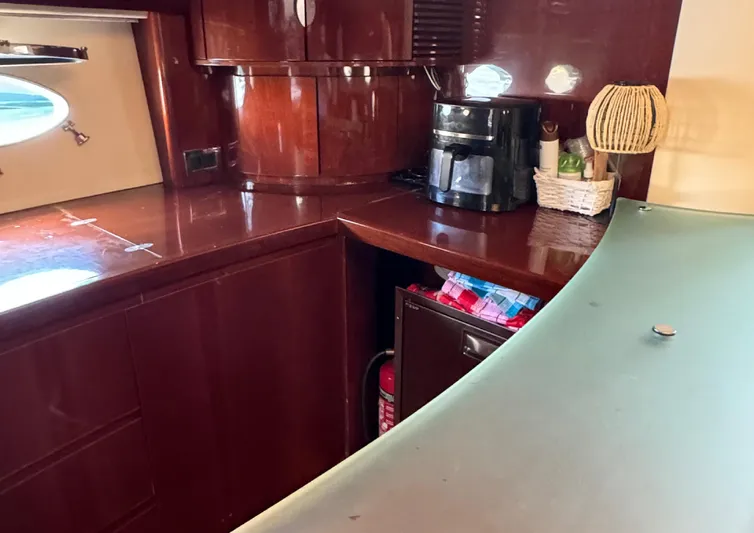  Yacht Photos Pics Luxurious 2004 Princess V65 yacht interior with wooden cabinetry and modern amenities.