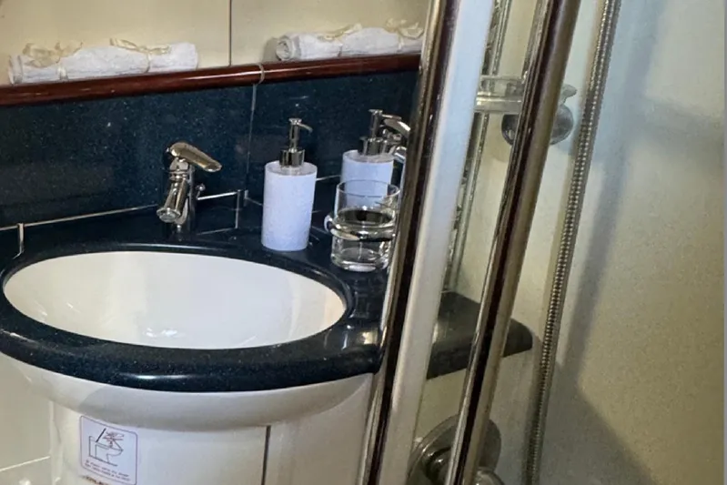  Yacht Photos Pics Luxurious bathroom in 2004 Princess V65 yacht with modern sink and shower.