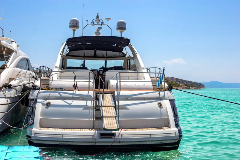  Yacht Photos Pics Luxury 2004 Princess V65 yacht docked in turquoise waters.