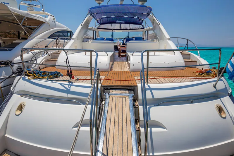  Yacht Photos Pics Luxury 2004 Princess V65 yacht docked, featuring spacious deck and elegant design.