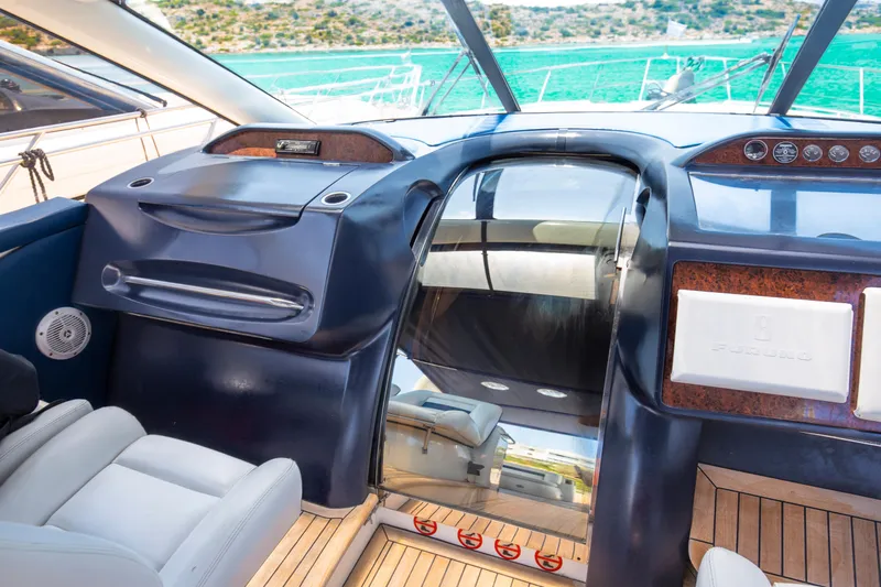  Yacht Photos Pics Interior view of a 2004 Princess V65 yacht cockpit with luxurious seating and controls.