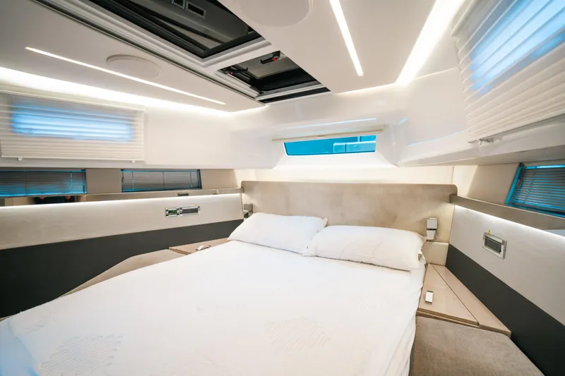  Yacht Photos Pics Luxurious bedroom interior of 2022 Fjord 52 Open yacht with modern design and ambient lighting.