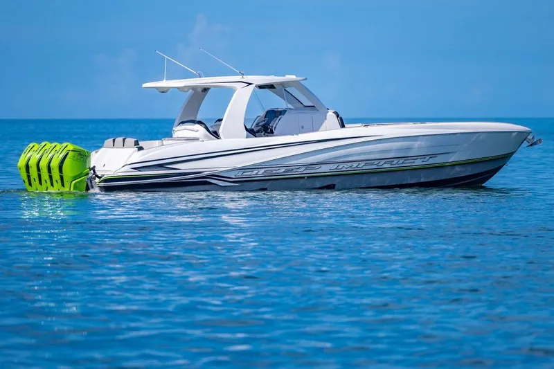  Yacht Photos Pics 2026 Deep Impact 399 Sport boat on calm blue water, featuring vibrant green engines.