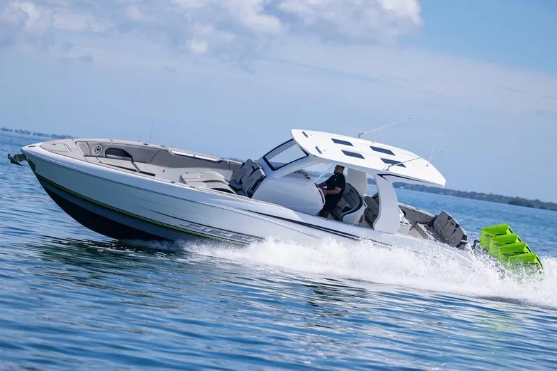  Yacht Photos Pics 2026 Deep Impact 399 Sport boat cruising on open water under a clear sky.