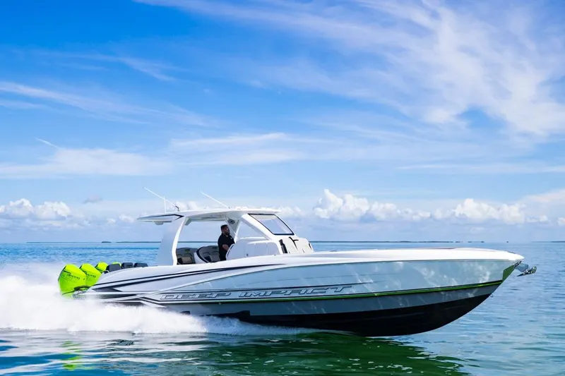  Yacht Photos Pics 2026 Deep Impact 399 Sport boat cruising on clear blue water under a sunny sky.