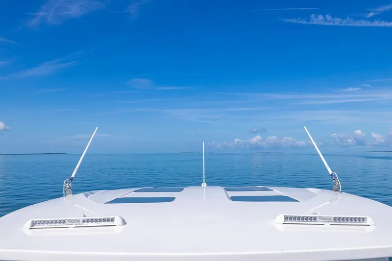  Yacht Photos Pics Bow of 2026 Deep Impact 399 Sport boat on calm ocean under clear blue sky.