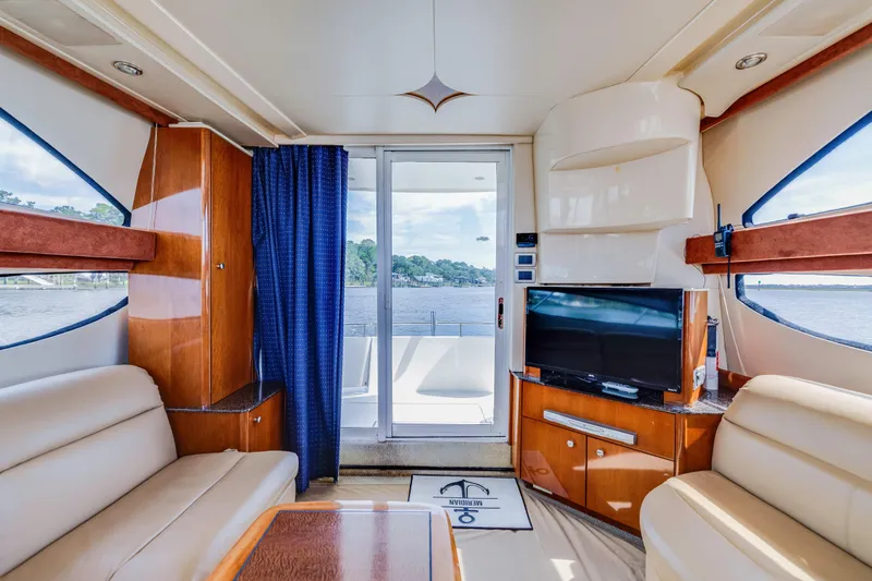  Yacht Photos Pics Luxurious interior of 2006 Meridian 341 Sedan yacht with TV and scenic water view.