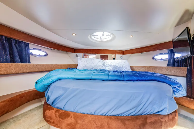  Yacht Photos Pics Luxurious interior cabin of 2006 Meridian 341 Sedan yacht with cozy bedding.