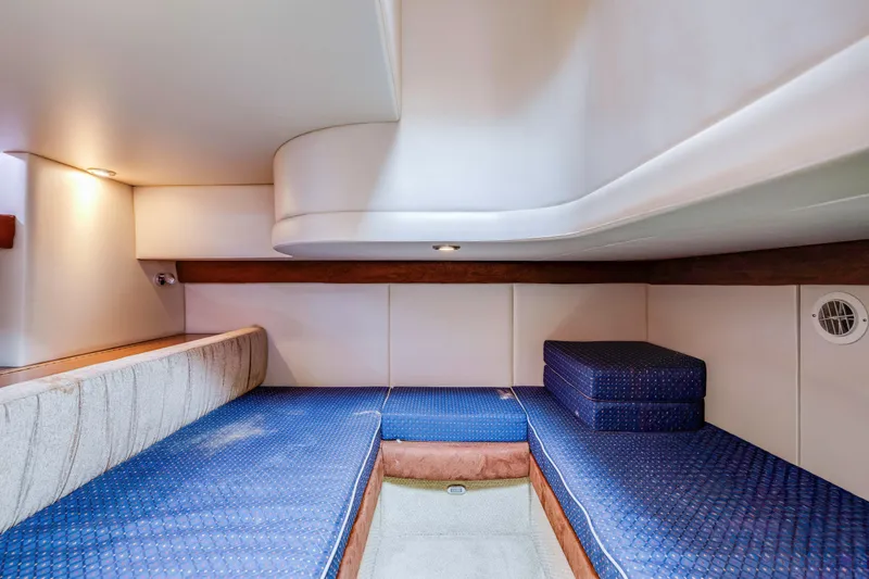  Yacht Photos Pics Interior cabin of 2006 Meridian 341 Sedan with blue cushioned seating.