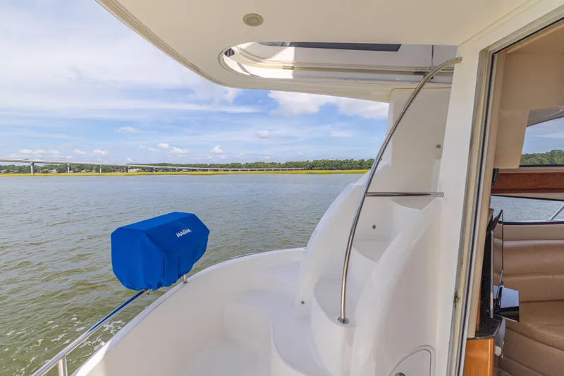  Yacht Photos Pics 2006 Meridian 341 Sedan yacht with scenic water view and blue cover.