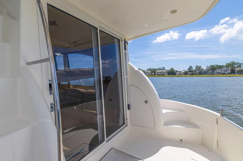  Yacht Photos Pics 2006 Meridian 341 Sedan yacht interior with water view, featuring sleek design and spacious seating.
