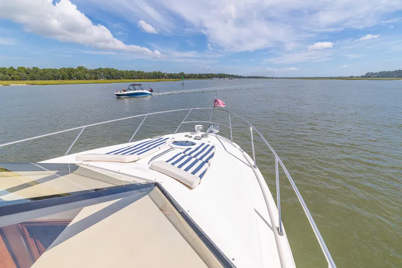  Yacht Photos Pics 2006 Meridian 341 Sedan cruising on a serene lake under a clear blue sky.