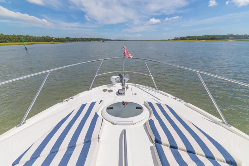  Yacht Photos Pics Bow view of 2006 Meridian 341 Sedan yacht on calm waters under blue sky.