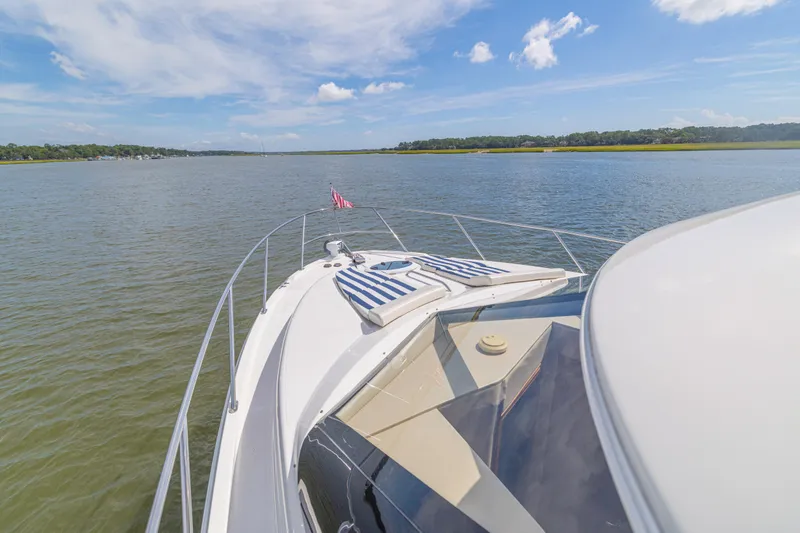  Yacht Photos Pics 2006 Meridian 341 Sedan yacht cruising on a serene lake under a clear blue sky.